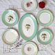 Old mismatched earthenware dinner plates with gold accompanied by a dish