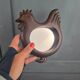 Vintage carved wooden chicken-shaped wall mirror.