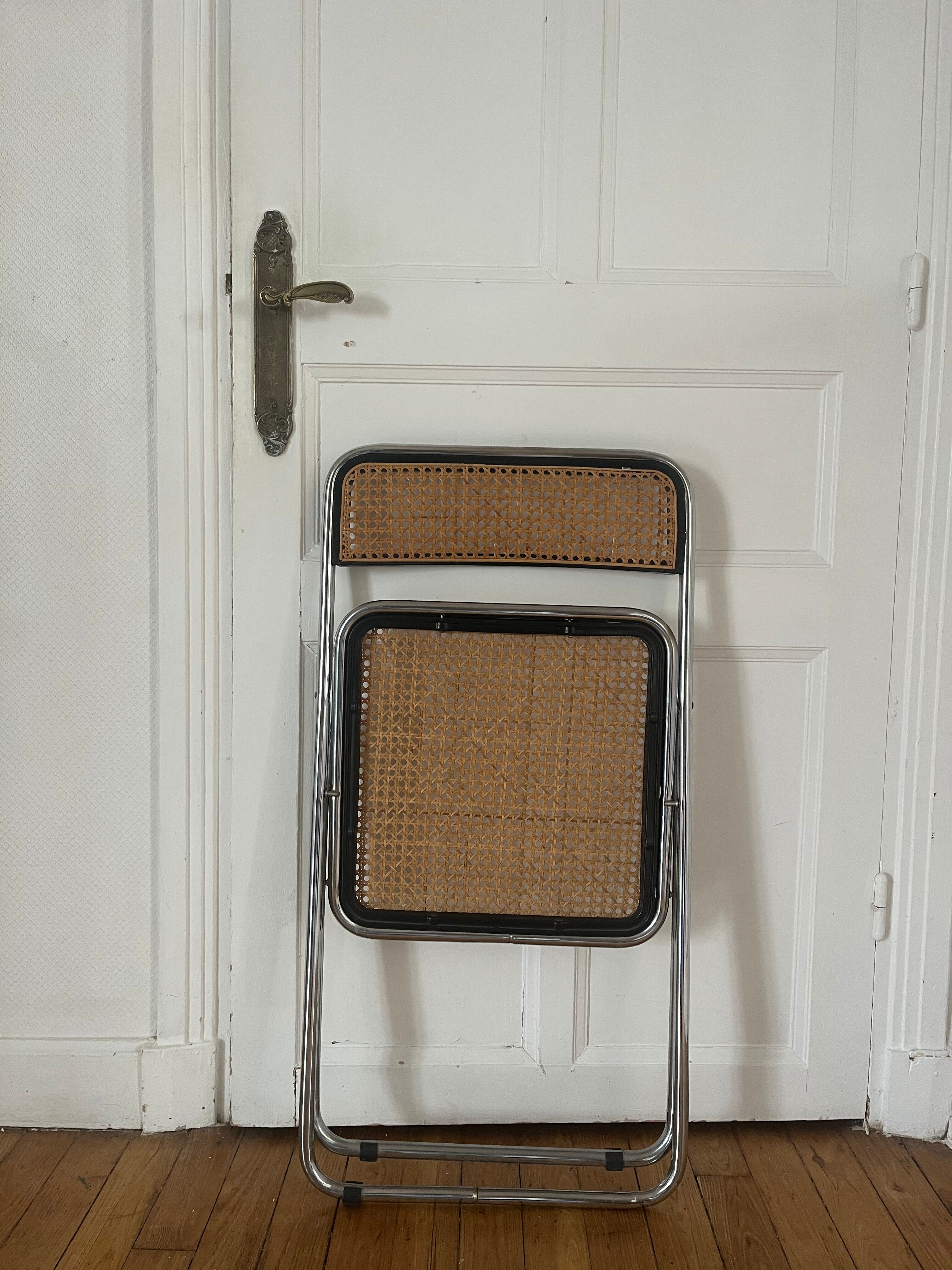 Vintage folding chair in metal and cane.
