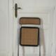 Vintage folding chair in metal and cane.