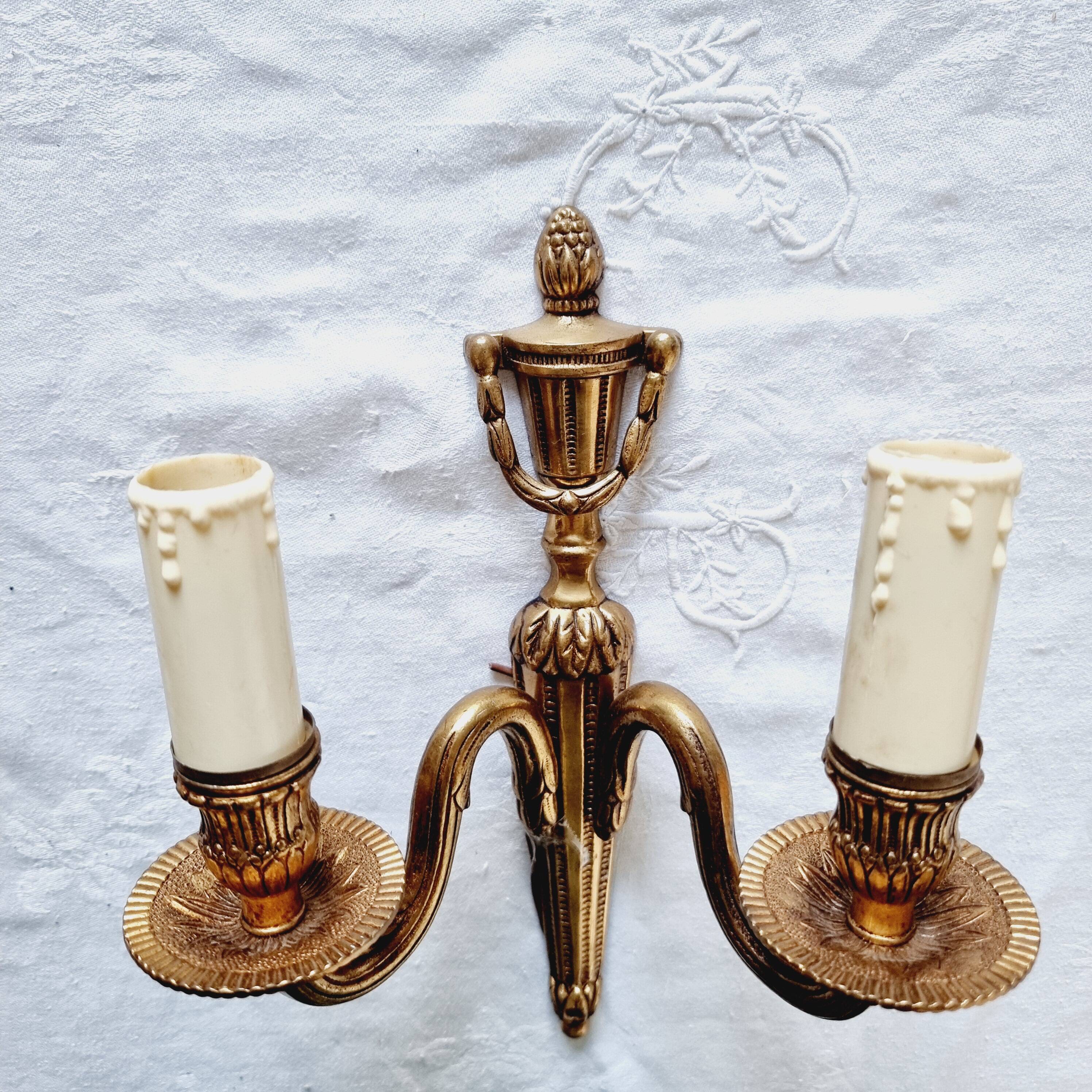 French Empire-style wall sconce or chandelier in bronze with an antique gold patina.
