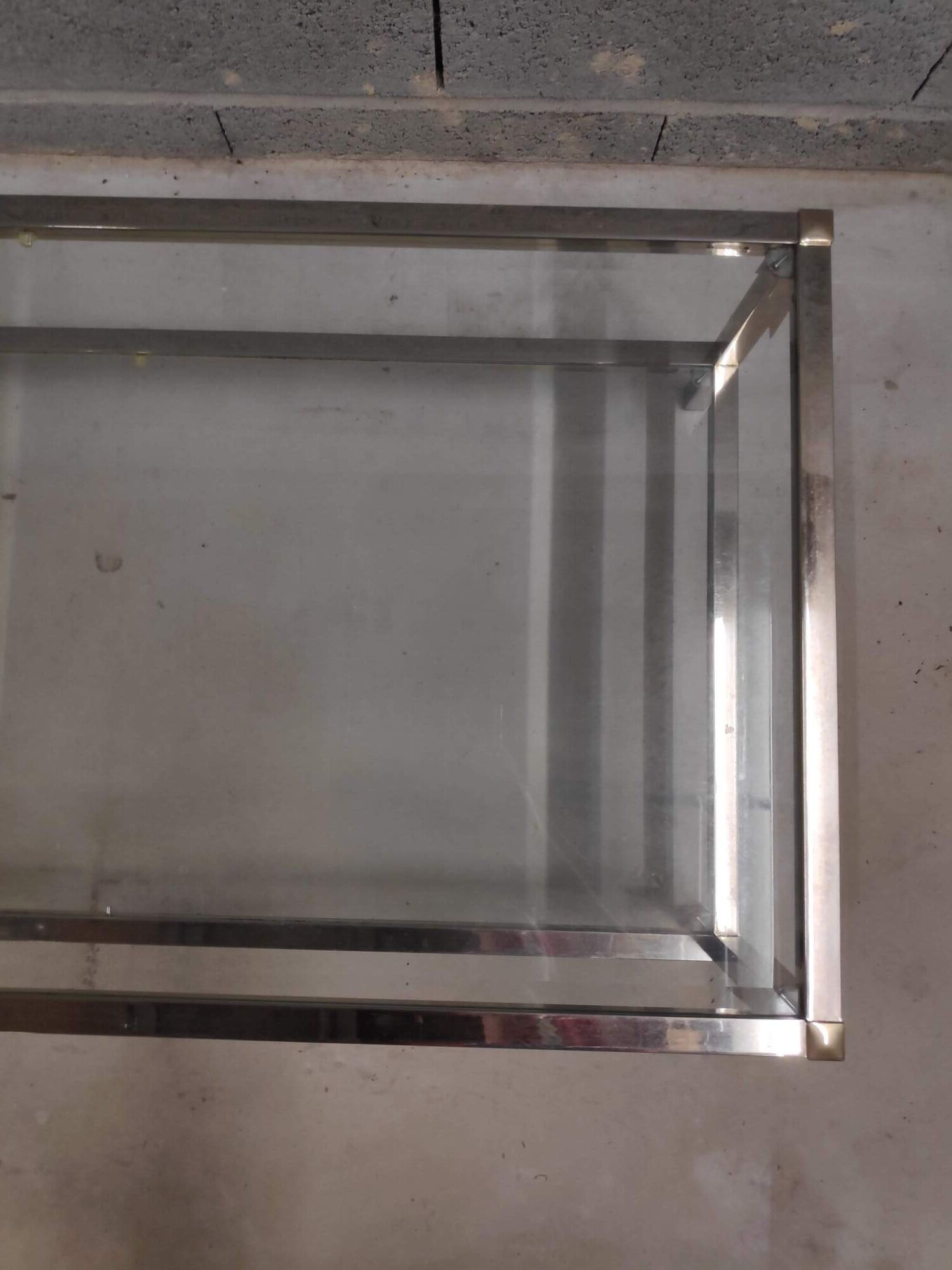 Vintage bevelled glass coffee table and lightly gilded square metal tubes from the 70s/80s