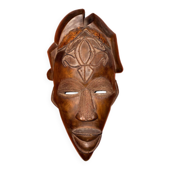 Tall carved mask with motifs