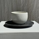 White Indonesian ceramic cup and gray saucer
