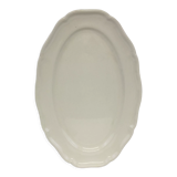 Old ivory-colored, oval-shaped dish with chamfered edge