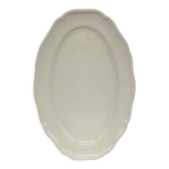 Old ivory-colored, oval-shaped dish with chamfered edge