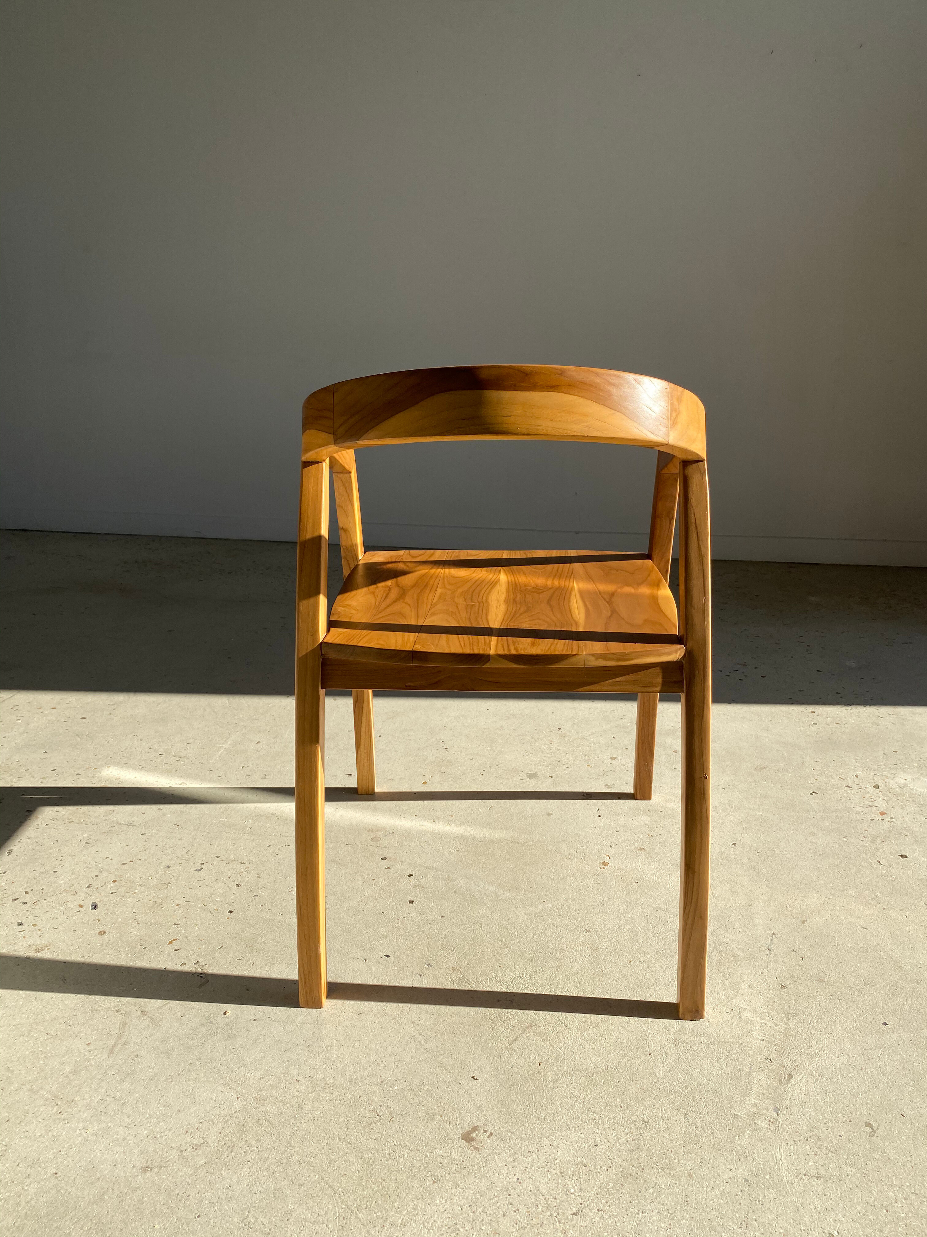 Natural wood chair with wraparound back