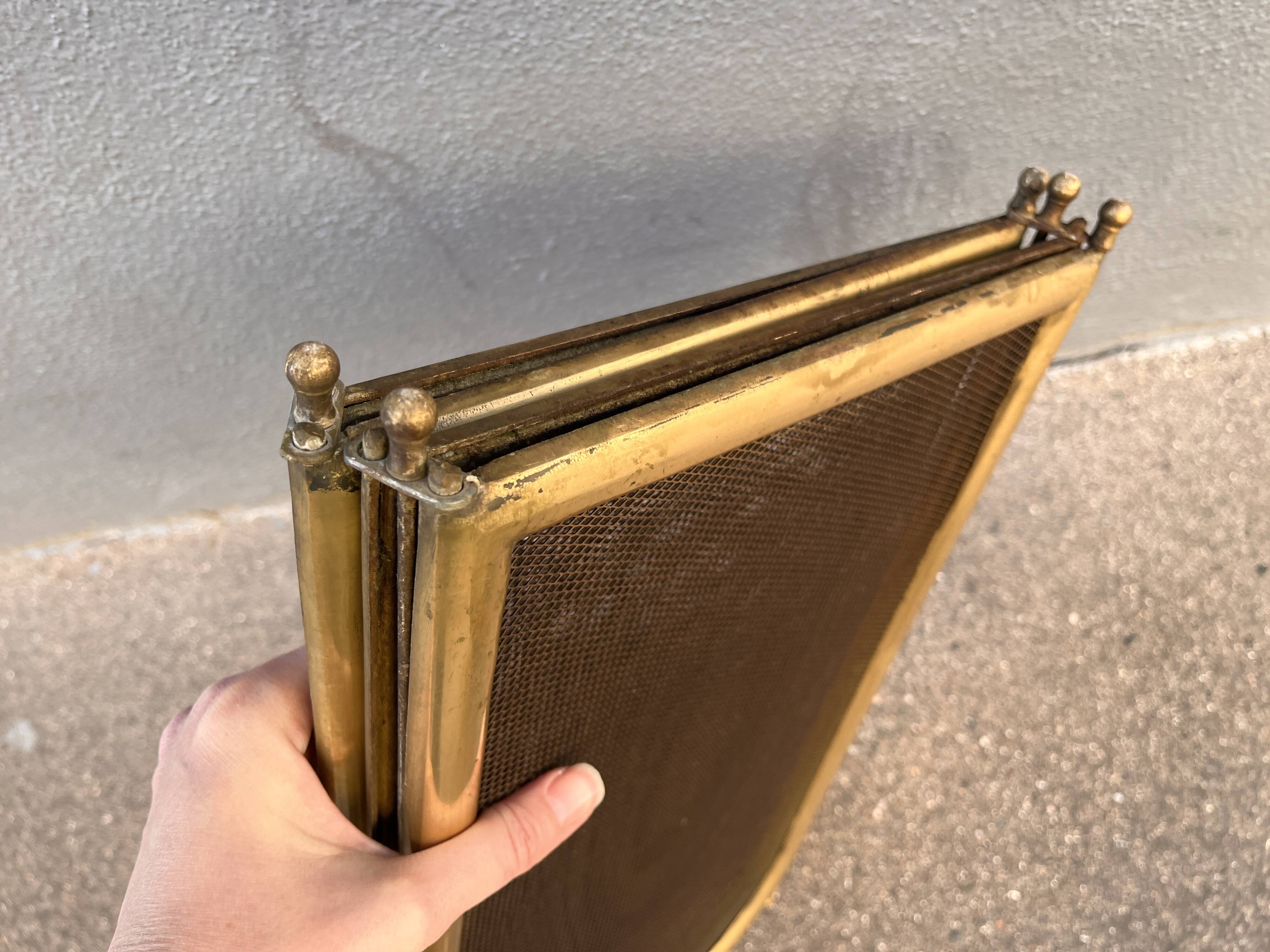 Antique brass fireplace screen from 1920, vintage spark guard.