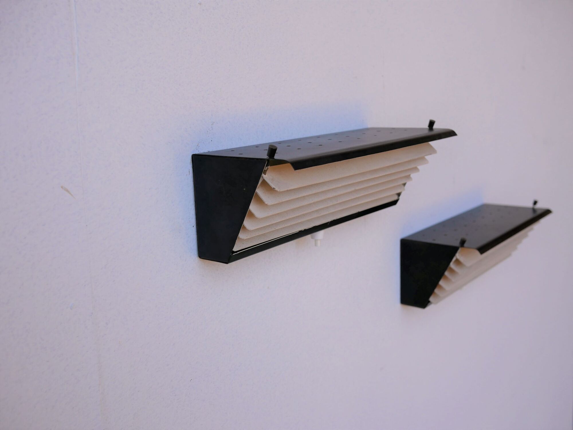Pair of modernist metal wall light model 212, by Jacques Biny for Luminalite