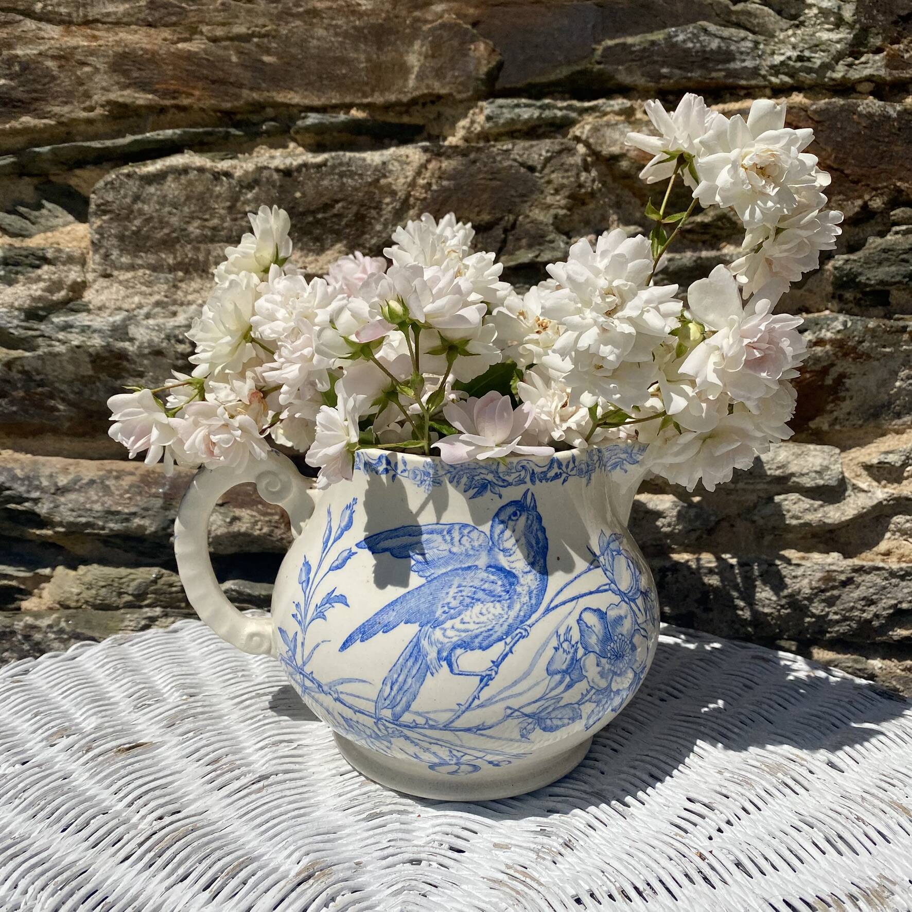 Earthenware pitcher decorated with birds.