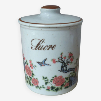 Old sugar box in speckled sandstone decorated with bird and flowering tree