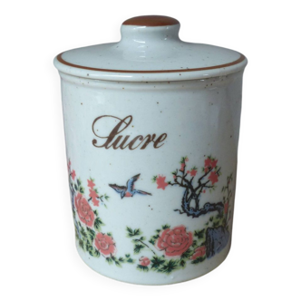 Old sugar box in speckled sandstone decorated with bird and flowering tree