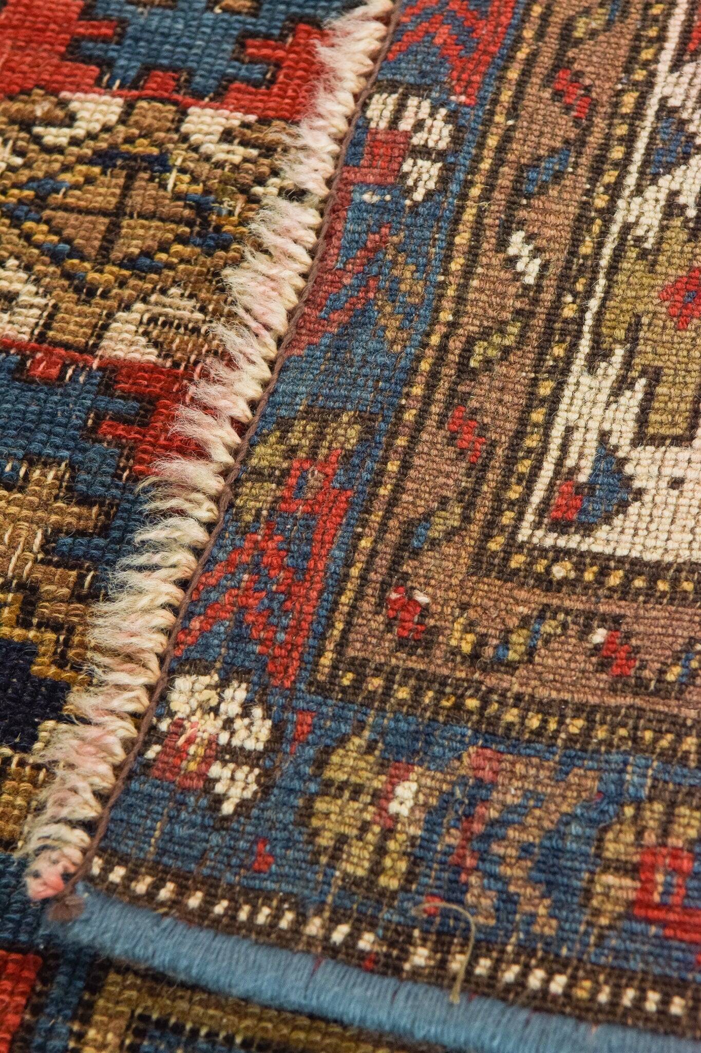 Handwoven Antique - Blue Ground Persian Rug with Bird-like Figures