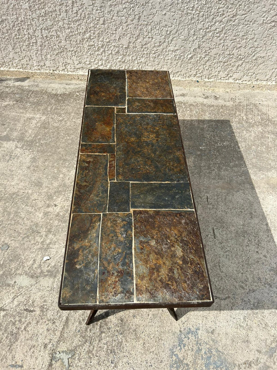 Coffee table with stone top and iron legs