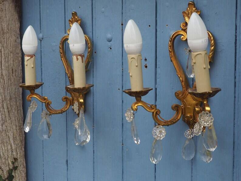 French antique Louis XV style twin arm wall sconces in bronze with crystals.