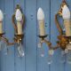 French antique Louis XV style twin arm wall sconces in bronze with crystals.