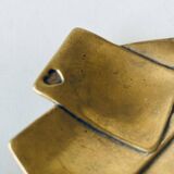 Empty pocket square of aces in brass