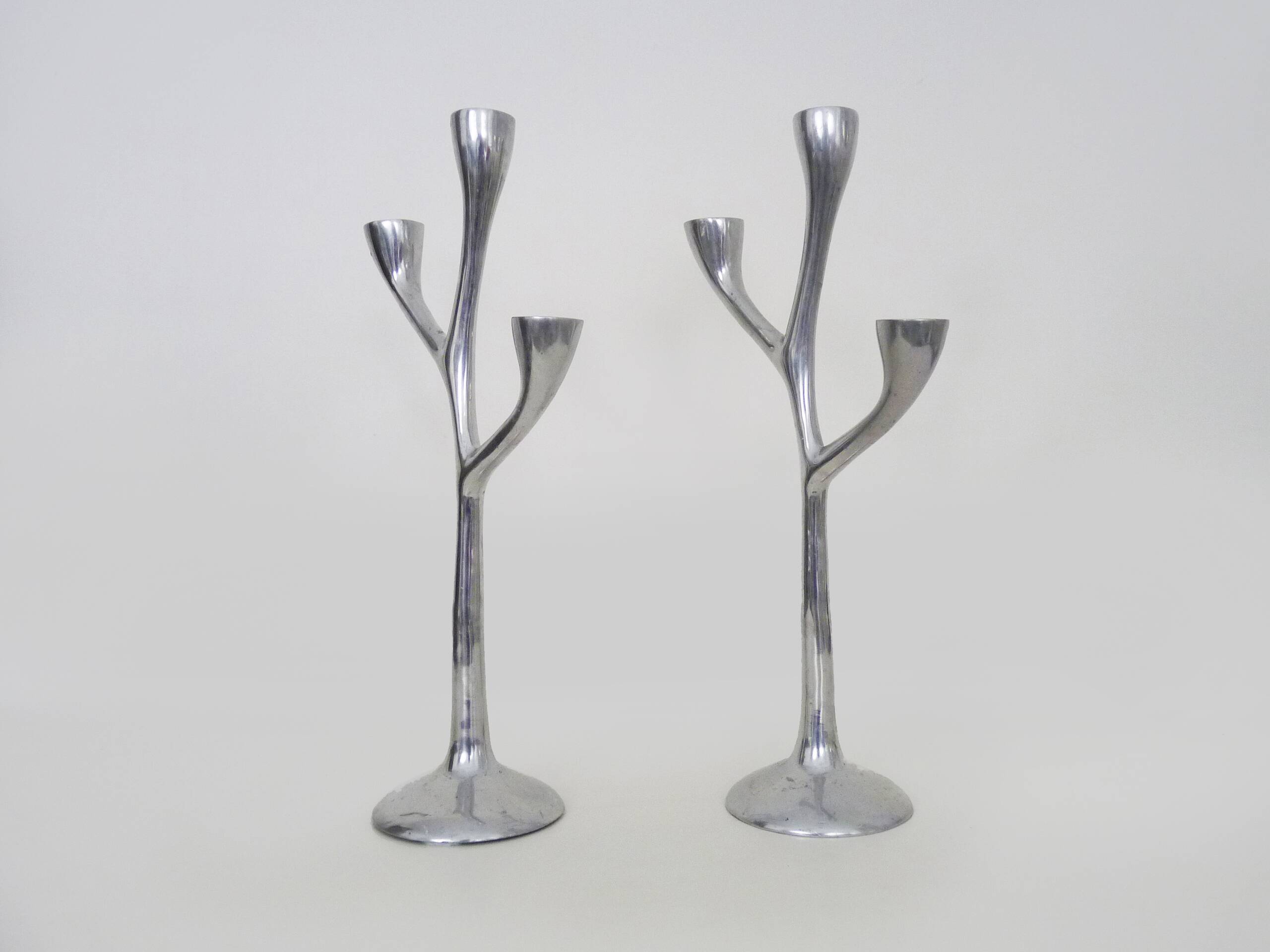 Pair of Italian "Tree" candlesticks in cast aluminum from the 80s