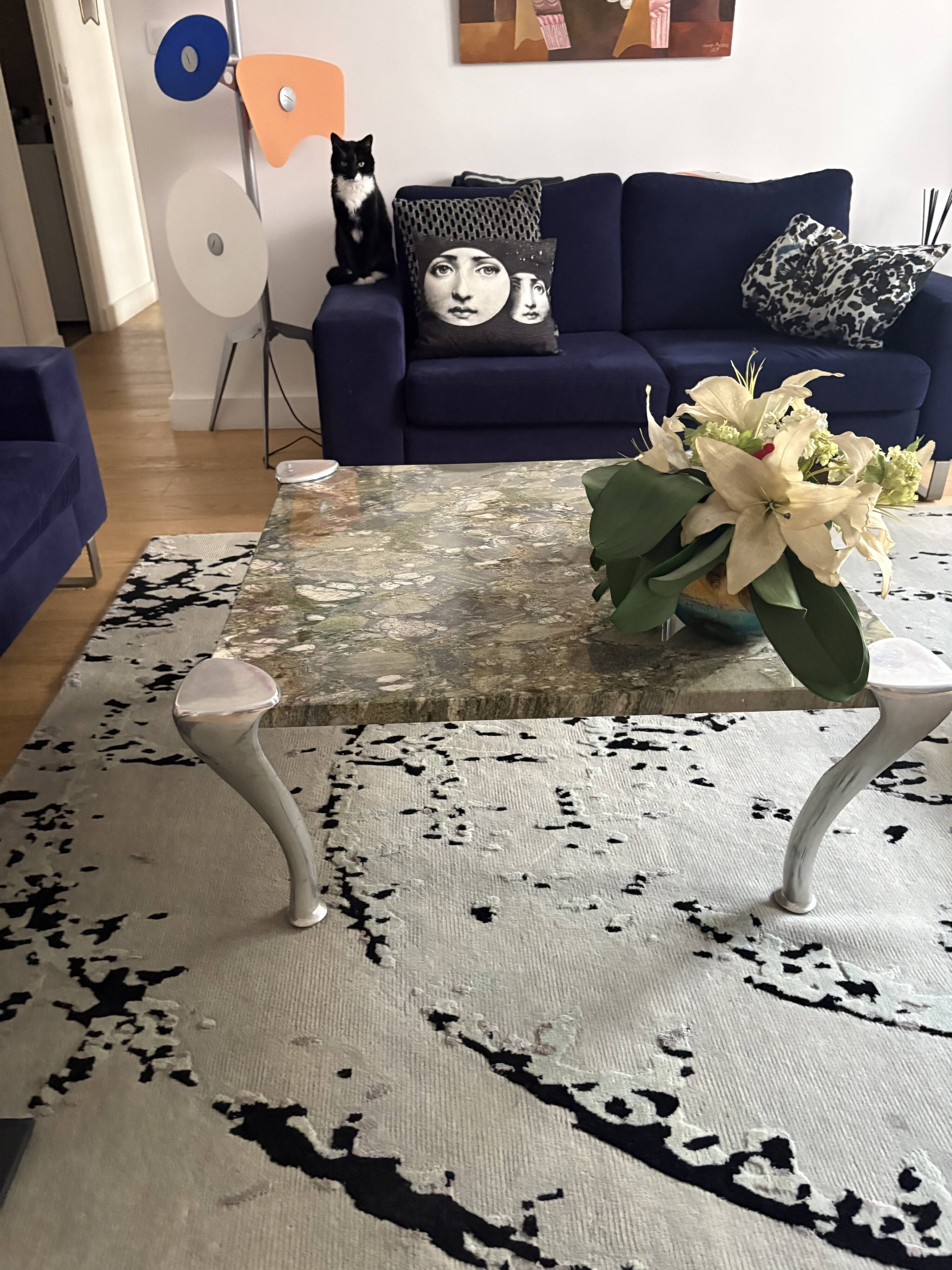 Contemporary coffee table with a marble top and steel base.
