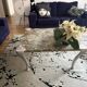 Contemporary coffee table with a marble top and steel base.