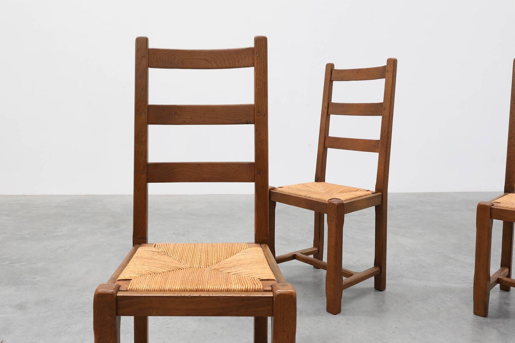 Set of 6 rustic oak ladder-back chairs with rush seats, France, 20th centur