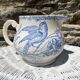 Earthenware pitcher decorated with birds.