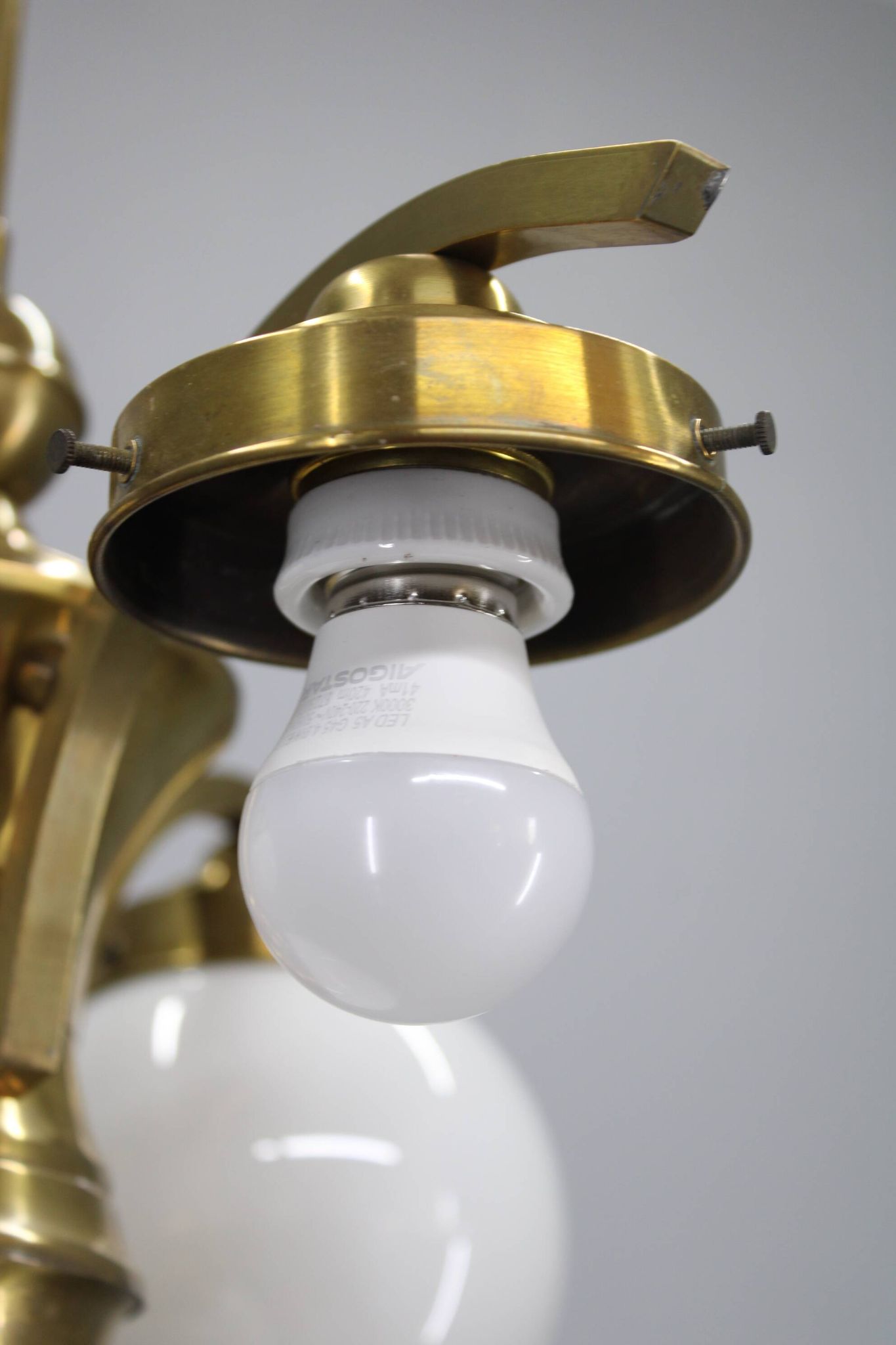1930s Czechoslovak Art Deco brass chandelier with four opaline glass globes
