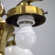 1930s Czechoslovak Art Deco brass chandelier with four opaline glass globes