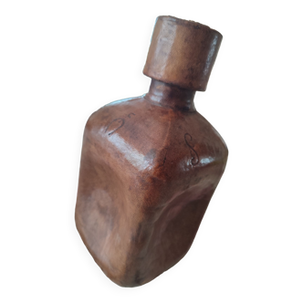 Amber bottle covered with leather