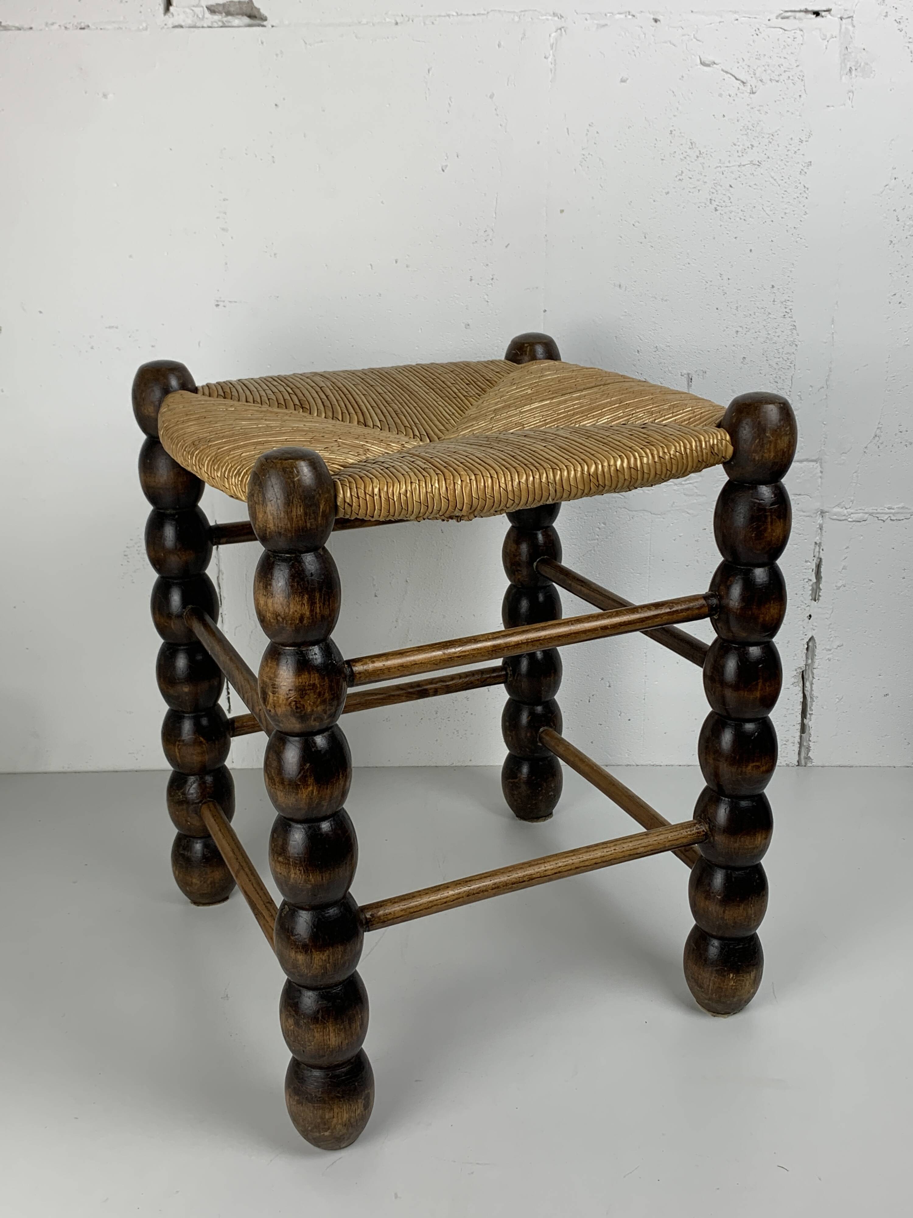 Brutalist wood turned bobbin rush stool in the style of Charles Dudouyt