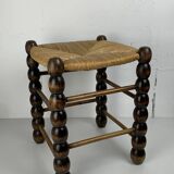 Brutalist wood turned bobbin rush stool in the style of Charles Dudouyt