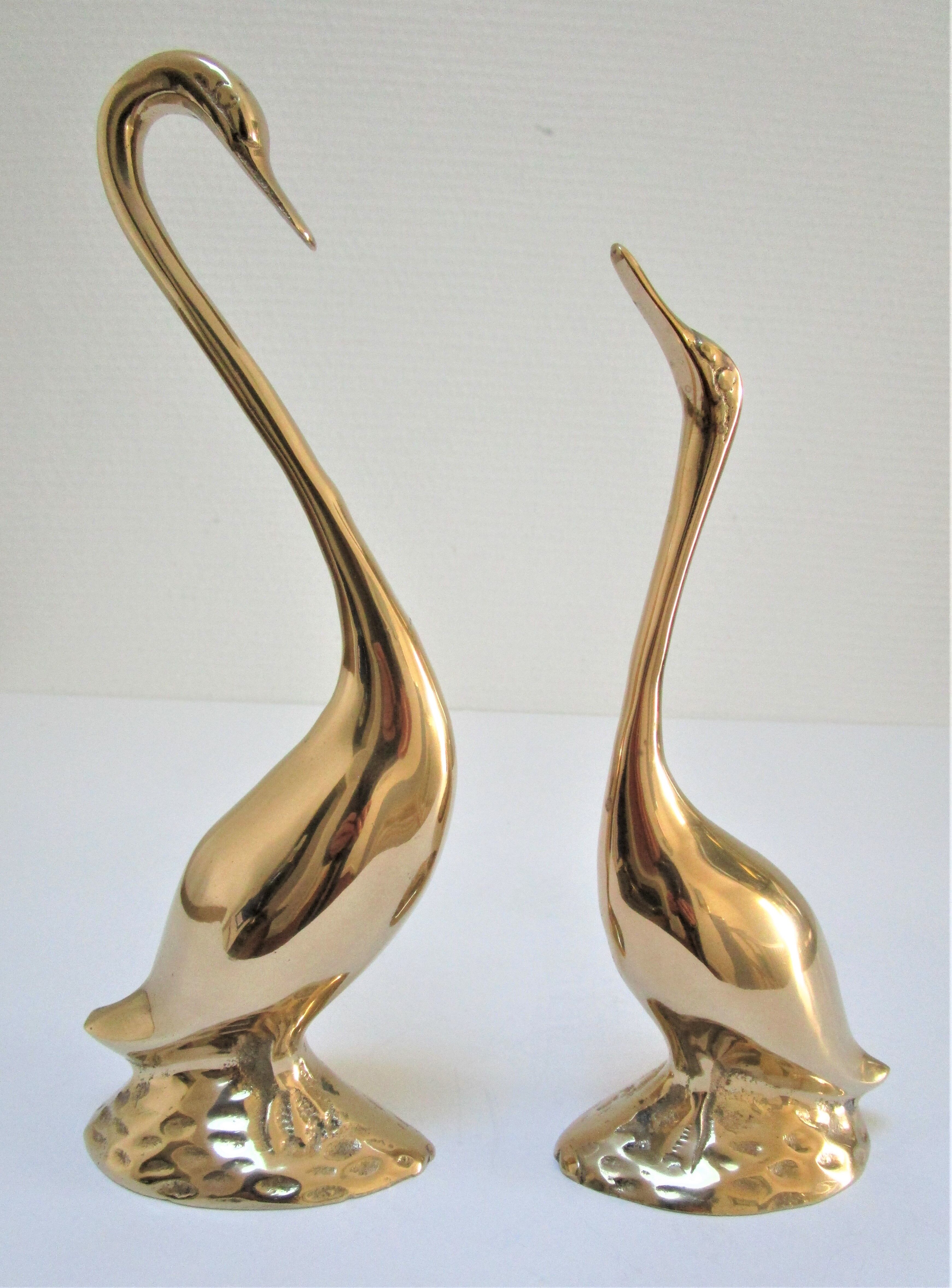Pair of stylized birds in solid brass