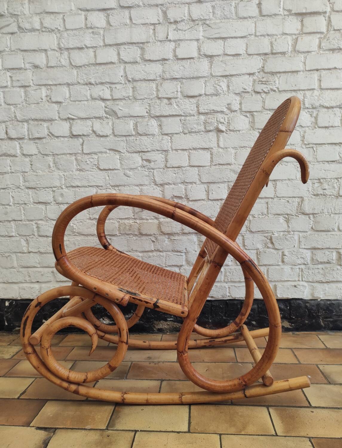 Vintage rocking chair in rattan and cane.