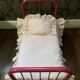 pink metal doll bed