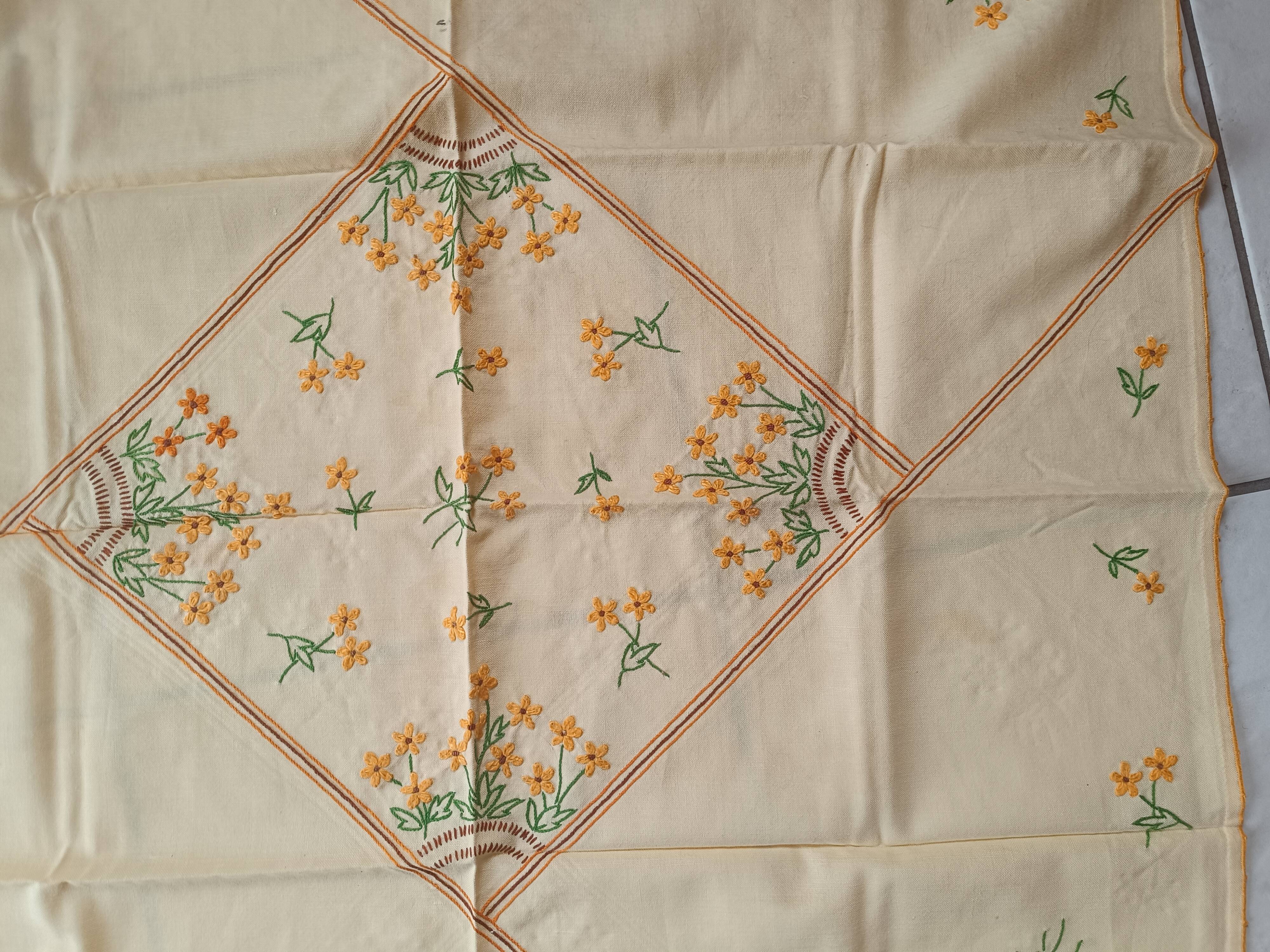 Hand-embroidered yellow square tablecloth.