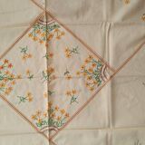 Hand-embroidered yellow square tablecloth.