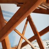 Old foldable stool in tinted wood