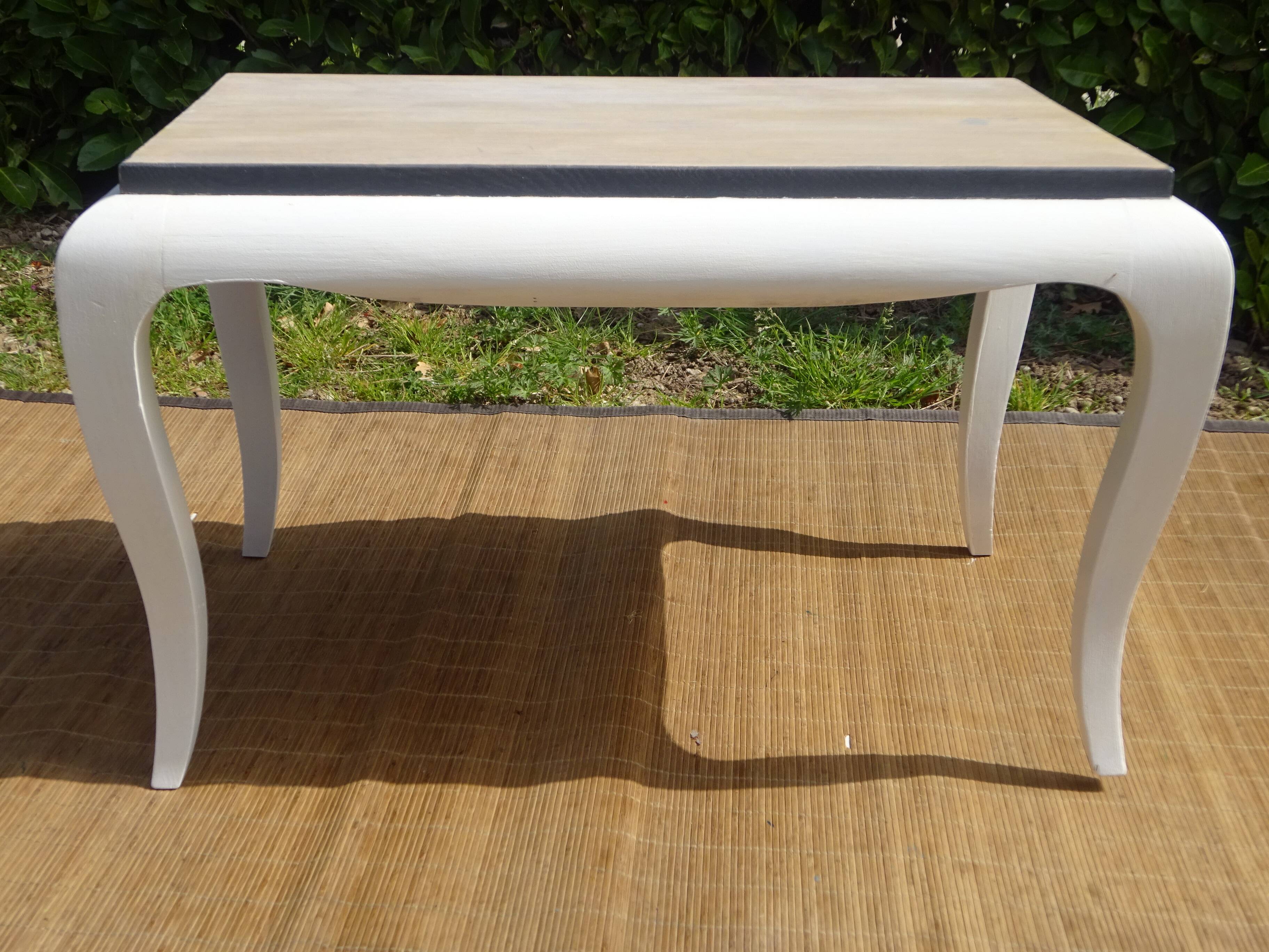 Oak coffee table with curved legs.
