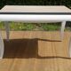 Oak coffee table with curved legs.