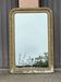Large Louis Philippe mirror in carved gilded wood with mercury glass.