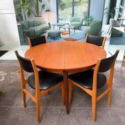 4 Scandinavian chairs in teak and black faux leather.