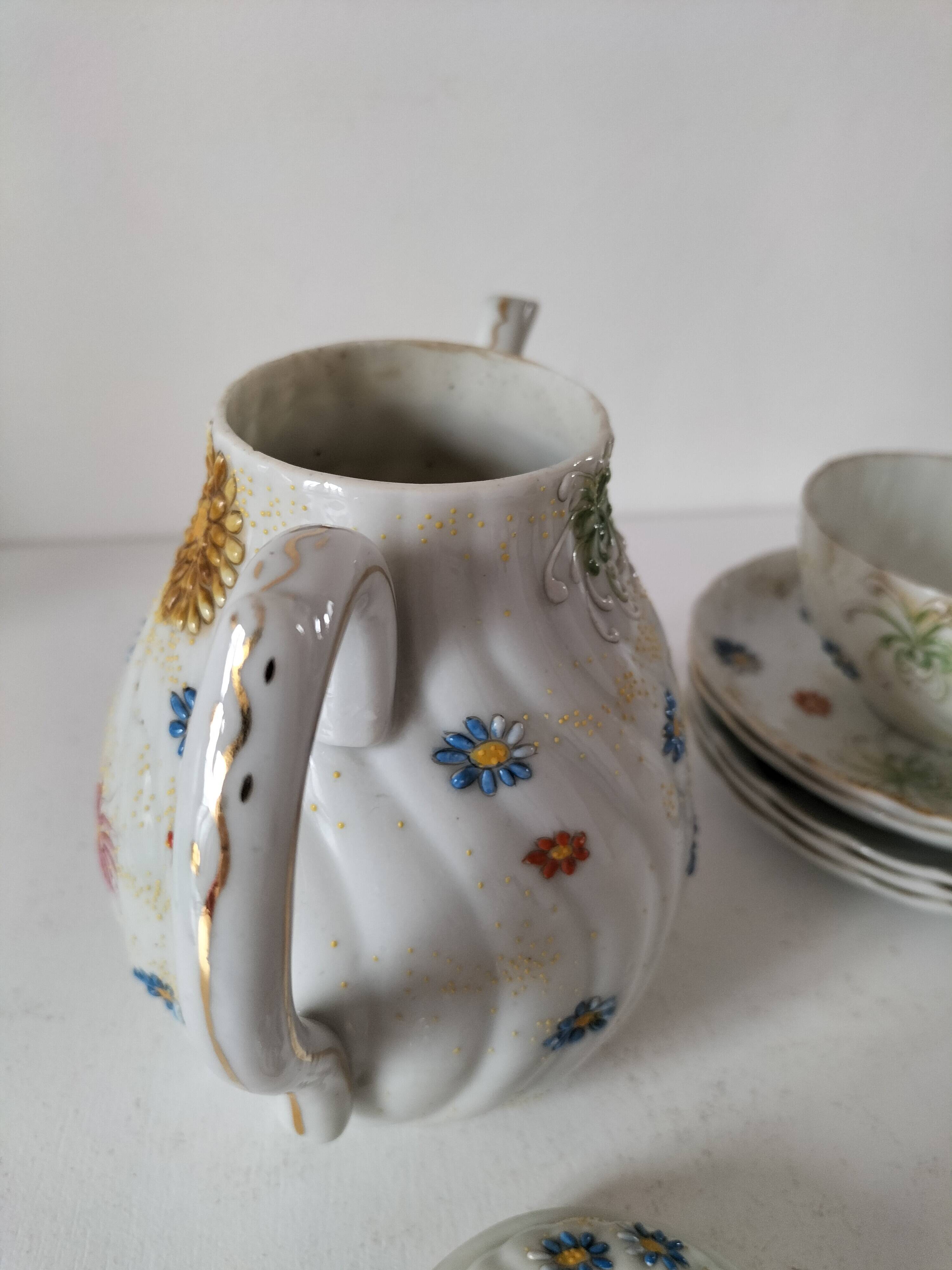 coffee pot, cup and saucers