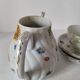 coffee pot, cup and saucers