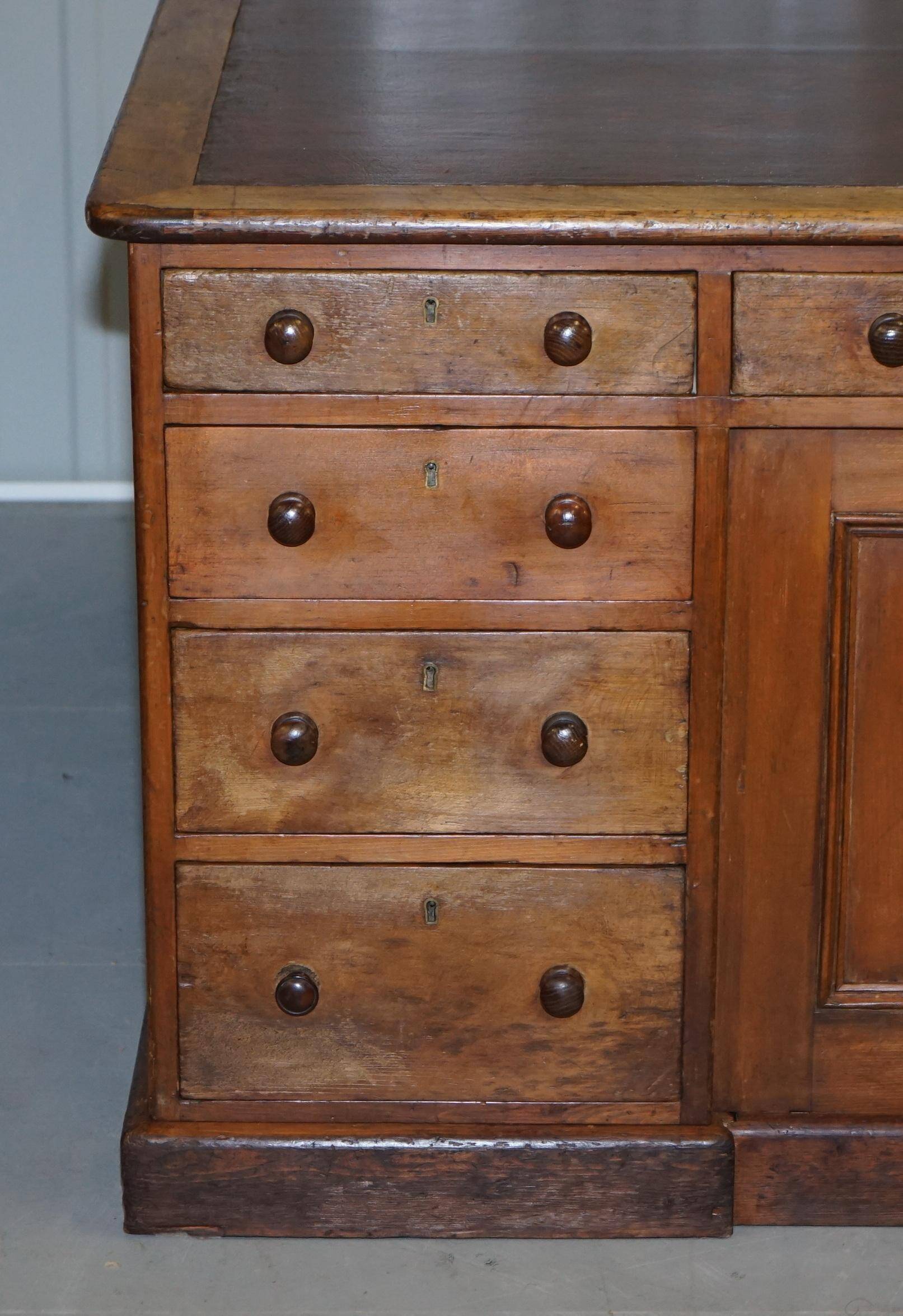 Antique Victorian oak kneehole desk with 18 double-sided drawers.