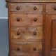 Antique Victorian oak kneehole desk with 18 double-sided drawers.