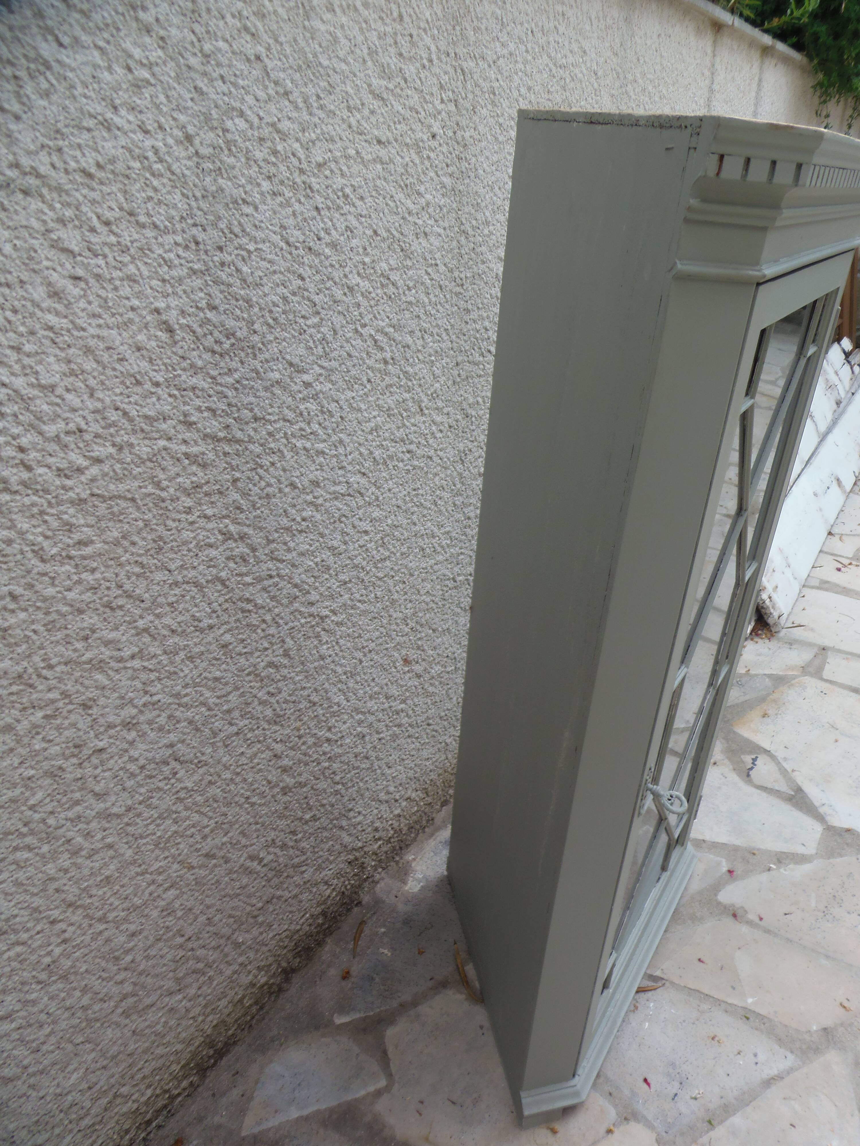Vintage English corner display cabinet enhanced in grey-green with a wooden top.