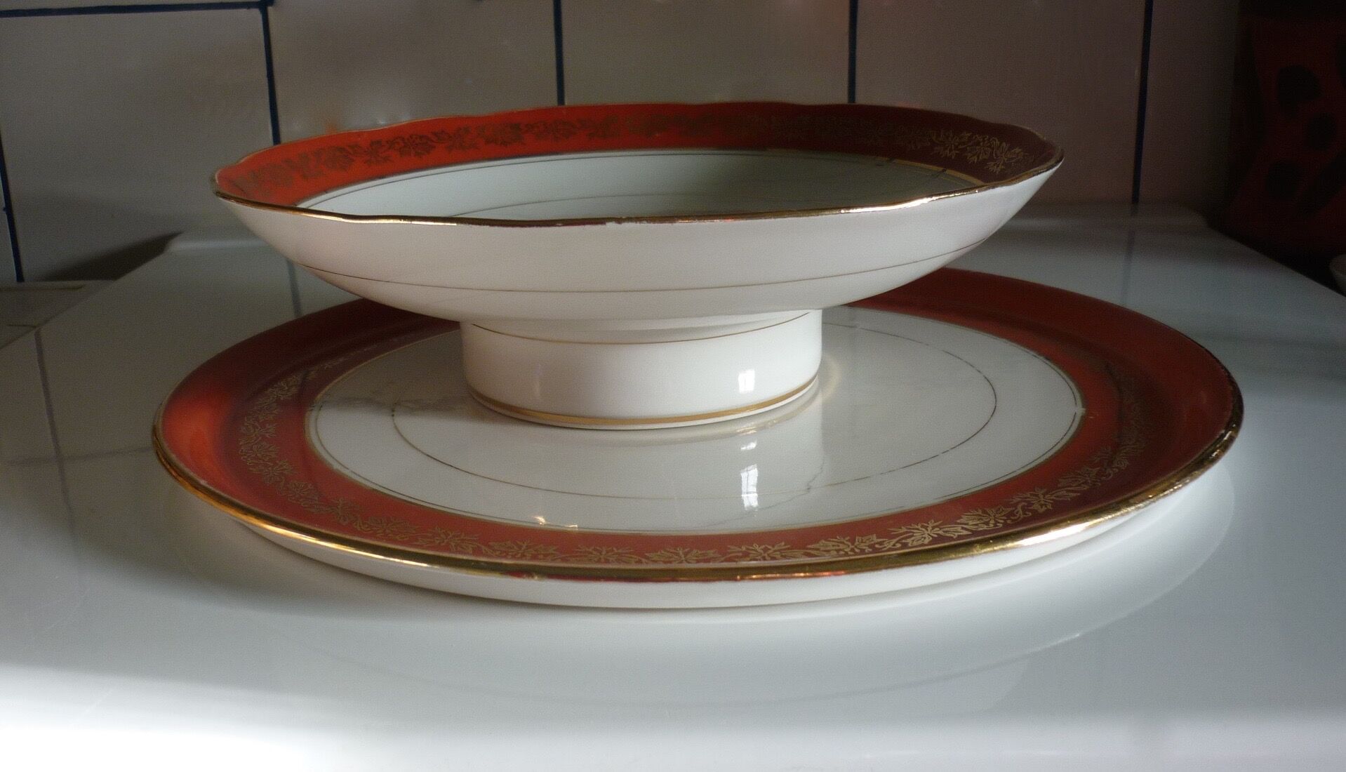 Plate and limoges porcelain dish with orange and gold trim
