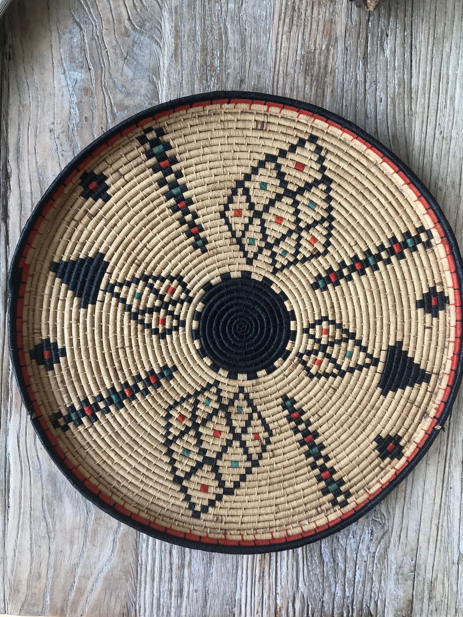 Braided wicker dish with ethnic motifs