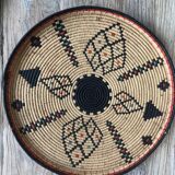 Braided wicker dish with ethnic motifs