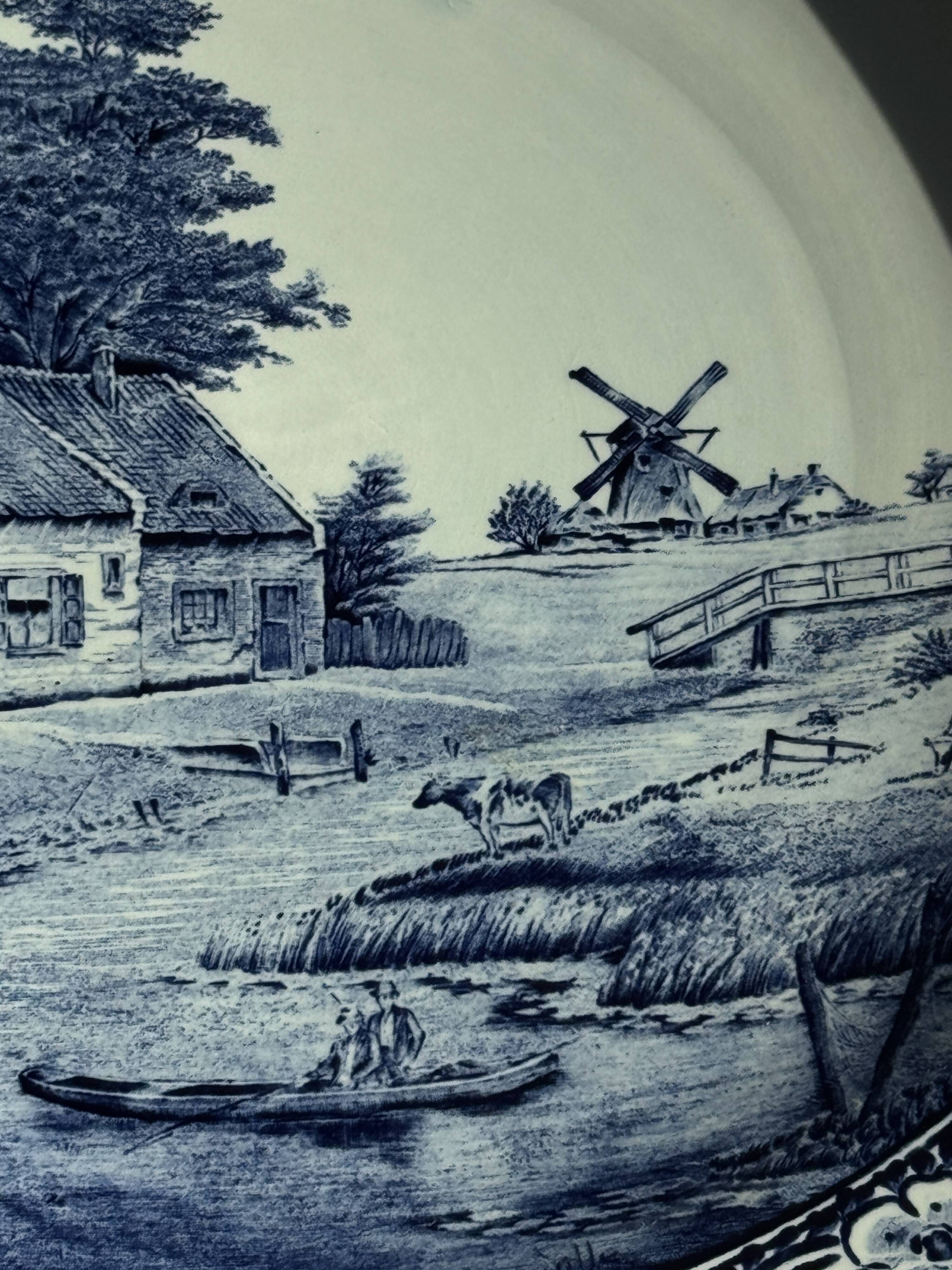 Vintage hollow circular plate in blue and white Boch pottery.